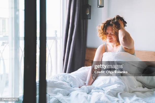 hangover. woman feel headache after party in the morning. - exhaustion stock-fotos und bilder