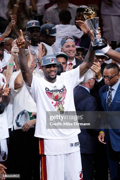 LeBron James of the Miami Heat celebrates with the Bill Russell Finals MVP trophy after they won 121-106 against the Oklahoma City Thunder in Game...