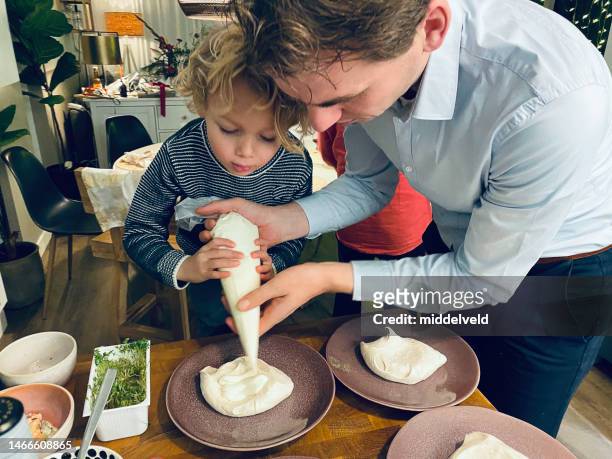 helping father with  the dessert - cheesecake white stock pictures, royalty-free photos & images