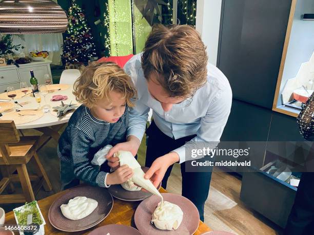 helping father with the dessert - netherlands christmas stock pictures, royalty-free photos & images