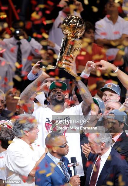 LeBron James of the Miami Heat celebrates with the Larry O'Brien Finals Championship trophy after they won 121-106 against the Oklahoma City Thunder...