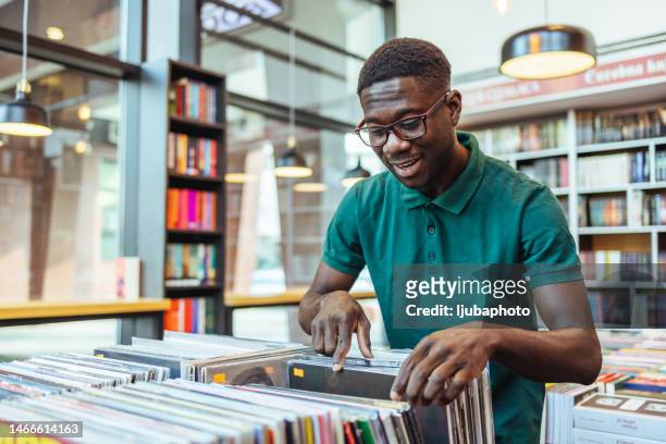 man shopping in a vinyl record store - collection stock pictures, royalty-free photos & images