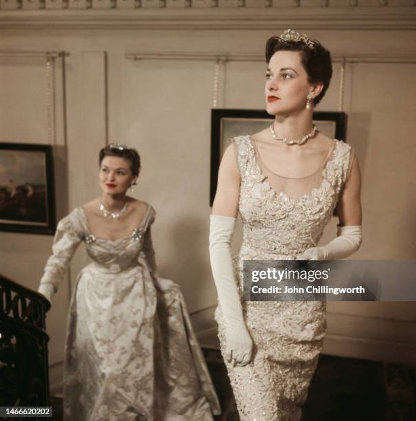 Two models wearing peeresses' dresses by designer Norman Hartnell, to be worn under robes for the coronation of Queen Elizabeth II, May 16th 1953....