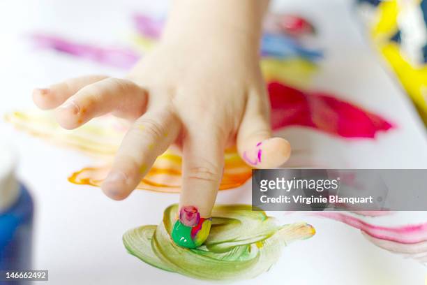 little one painting for his teacher - baby paint hand stock-fotos und bilder