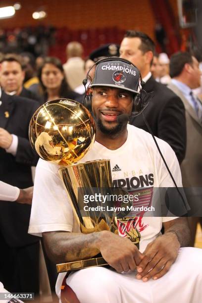 LeBron James of the Miami Heat talks to the media while holding the Larry O'Brien NBA Championship Trophy after his team wins the NBA Championship by...