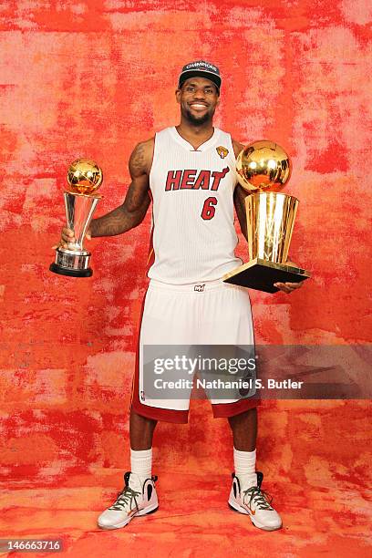 LeBron James of the Miami Heat poses for a portrait with the Larry O'Brien and Finals MVP Trophy after winning the Championship against the Oklahoma...