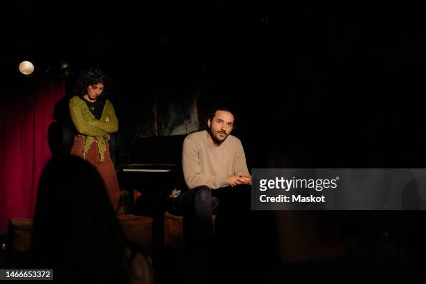 female and male actors performing together for audience at amateur theater - amateur theater fotografías e imágenes de stock