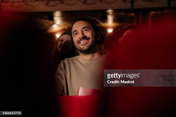 smiling man watching film at movie theater - bio bildbanksfoton och bilder