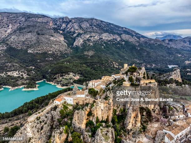 aerial view, landscape with a small ancient village on the top of a rock formation. guadalest, alicante. - alicante street stock pictures, royalty-free photos & images