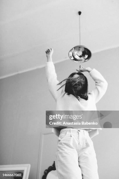 young woman jumping on the bed - ukrainian dancer stock pictures, royalty-free photos & images