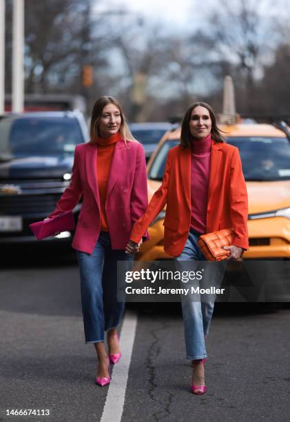 Annette Weber seen wearing an orange Bottega Veneta Cassette bag, a pink turtle neck and an orange blazer, wide leg jeans all by Peter Hahn and pink...