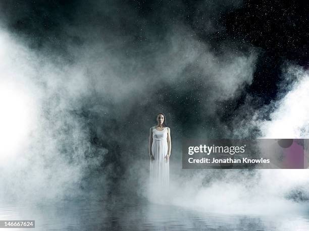 Female in white in rain,  misty night