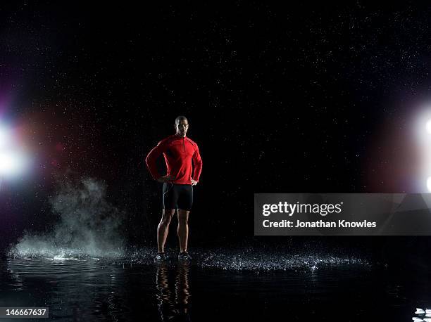 portrait of an athlete standing in water - läufer dramatisch stock-fotos und bilder