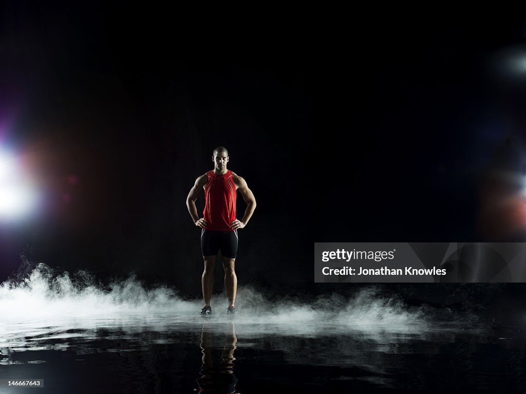 Athelete standing in water at night