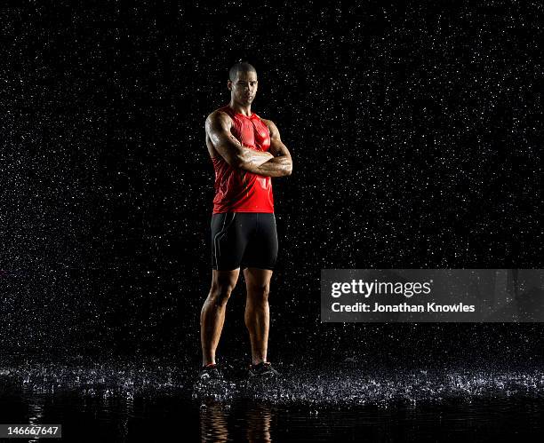 athlete standing in rain - standing in the rain stock pictures, royalty-free photos & images