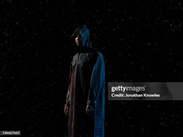 man in a raincover - raincoat stock pictures, royalty-free photos & images