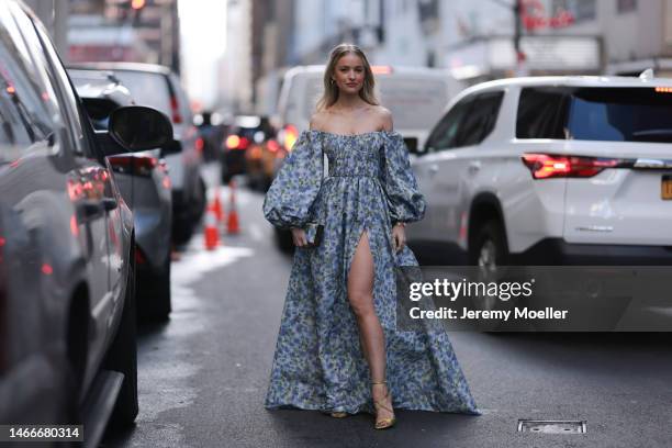 Victoria Magrath seen wearing a blue shoulder free dress with puff sleeves, a matching bag and green heels before the Carolina Herrera show on...