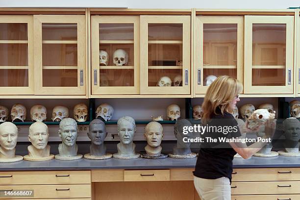 Quantico, VA completed Facial Approximations of unidentified found remains sit as Lisa Bailey, a forensic artist, and Dr. Richard Thomas, a forensic...