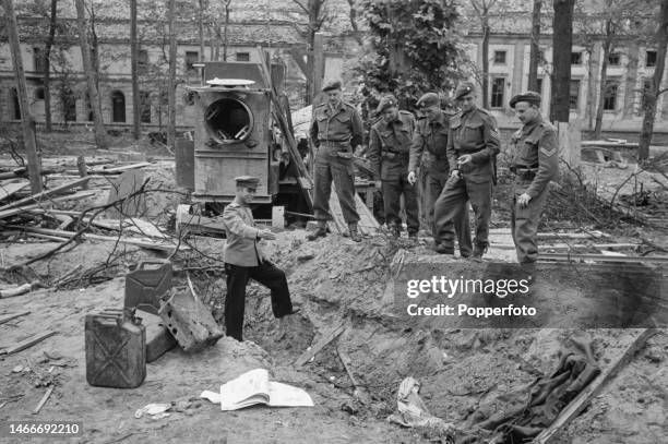 Group of British soldiers from the Royal Army Service Corps are shown the supposed gravesite of German Fuhrer Adolf Hitler and his wife Eva Braun in...