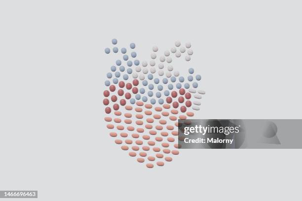 pills in the shape of a human heart. - 人体実験 ストックフォトと画像