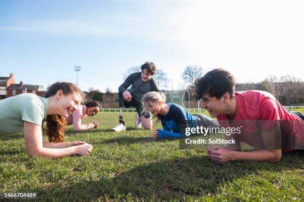 doing the plank - team building activity stock pictures, royalty-free photos & images