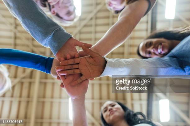 hands in the middle - african american basketball stock pictures, royalty-free photos & images