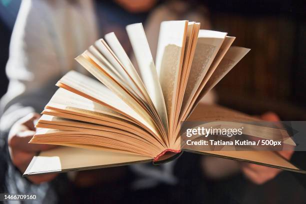 open old book in bright sunlight close-up,russia - publisher stock pictures, royalty-free photos & images