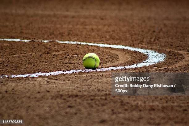 the baseball fell right over the sidelines during a practice game on the field one morning,indonesia - softball sport stock pictures, royalty-free photos & images