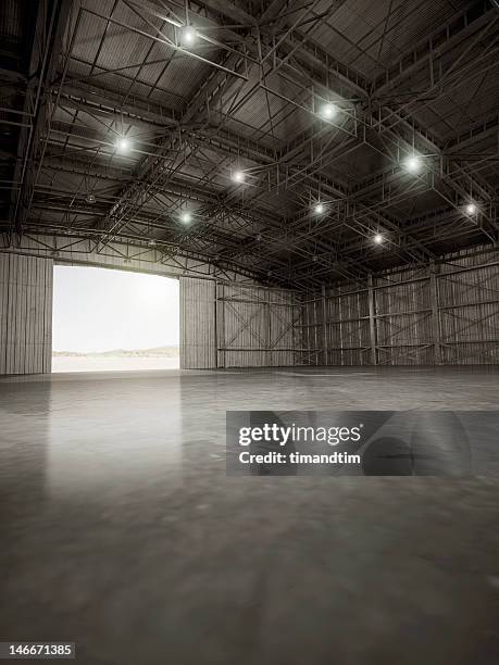 empty hangar with lights on - hangar fotografías e imágenes de stock
