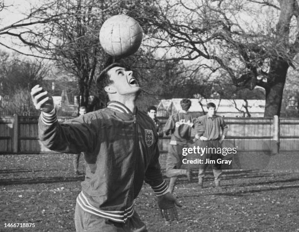 Geoff Hurst, England international footballer and Forward for West Ham United Football Club practicing heading the football during a training session...