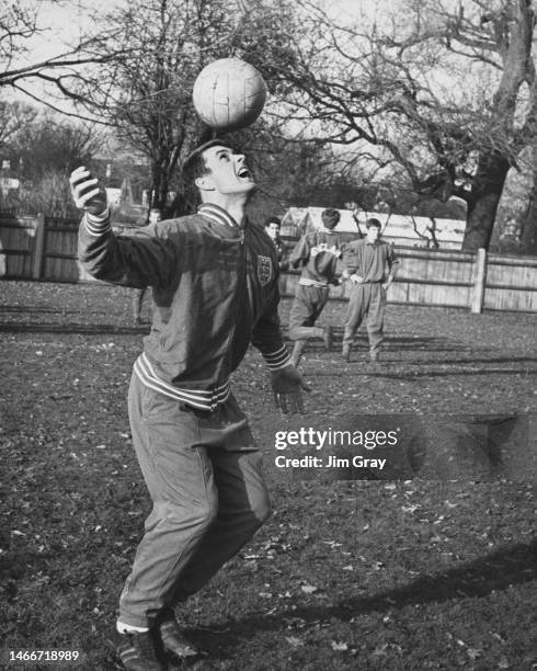 Geoff Hurst, England international footballer and Forward for West Ham United Football Club practising heading the football during a training session...