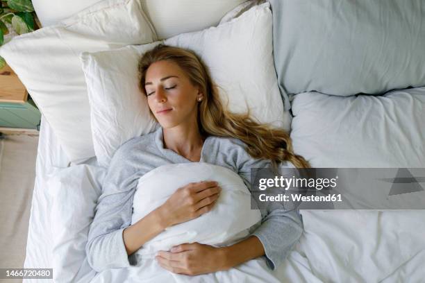 woman sleeping in bedroom at home - female sleeping stock pictures, royalty-free photos & images