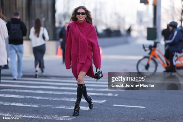 Emili Sindlev seen wearing a pink turtle neck knit dress, a pink sweater, a black mini bag, black shades and black leather boots before the Michael...