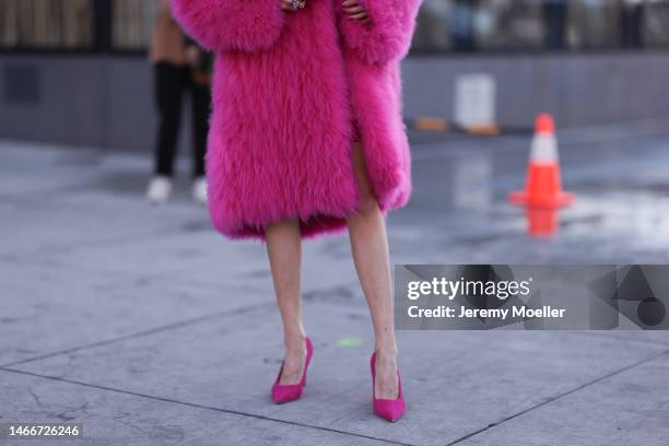 Leonie Hanne seen wearing a pink fur coat, a pink sequins dress, pink heels and a matching pink bag before the Michael Kors show on February 15, 2023...