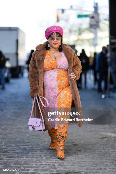 Guest wears a pink with white small checkered print pattern wool beret from Kangol, brown sunglasses, pale purple long pendant pattern earrings, a...