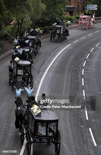 Horse drawn hearses travel to St Mary's Church carrying the coffins of the six Philpott children on June 22, 2012 in Derby, England. Hundreds of...