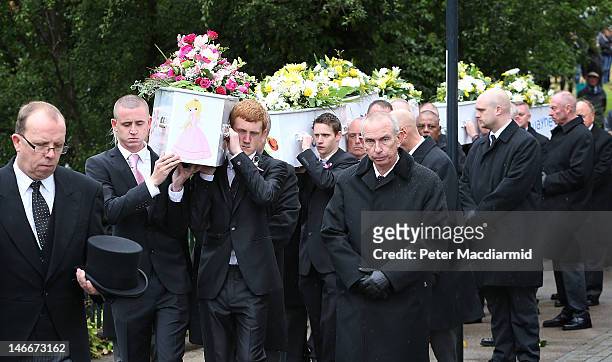 Pallbearers carry the coffins of the six Philpott children to St Mary's Church on June 22, 2012 in Derby, England. Hundreds of people gathered for...