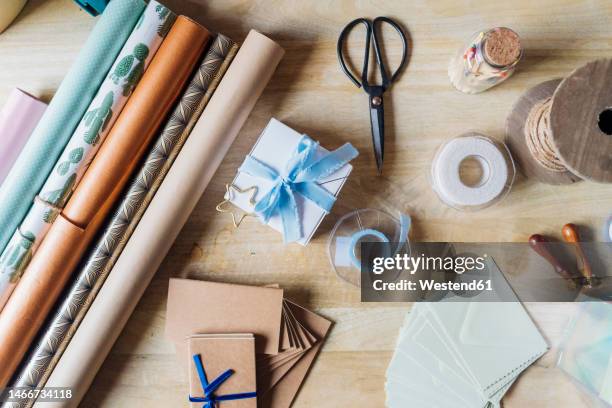 wrapping paper with gifting material on desk - roll of wrapping paper stock pictures, royalty-free photos & images