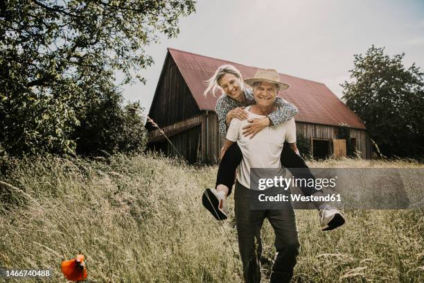 playful couple enjoying in field - couple farm stock pictures, royalty-free photos & images