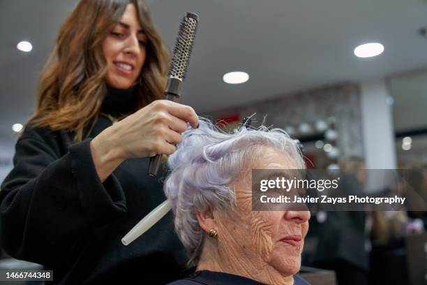 senior woman getting new hair cut at beauty salon - new hairstyle stock pictures, royalty-free photos & images