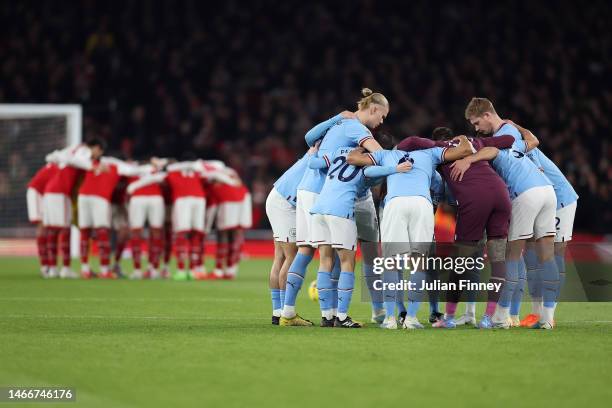 Arsenal and Manchester City teams huddle before the Premier League match between Arsenal FC and Manchester City at Emirates Stadium on February 15,...