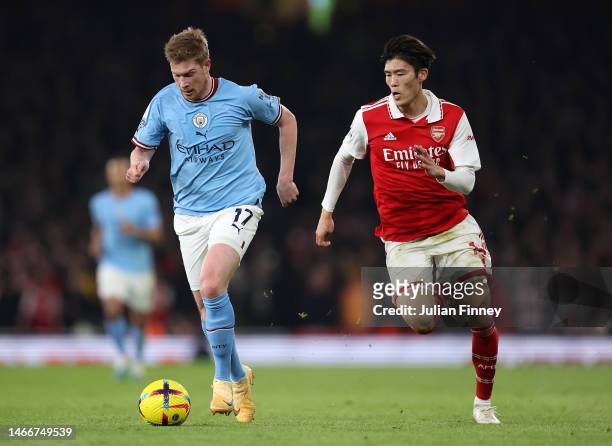 Kevin De Bruyne of Manchester City moves away from Takehiro Tomiyasu of Arsenal during the Premier League match between Arsenal FC and Manchester...