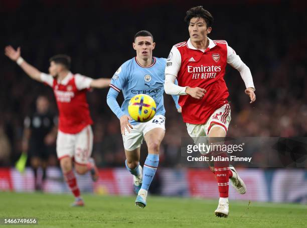Takehiro Tomiyasu of Arsenal moves away from Phil Foden of Manchester City during the Premier League match between Arsenal FC and Manchester City at...
