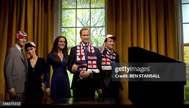 Waxworks figures of former England footballer David Beckham, his wife Victoria, Catherine, Duchess of Cambridge, Prince William and British Prime...