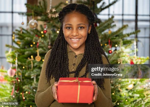 cheerful young black girl in holiday home interior - giving a girl head stock pictures, royalty-free photos & images