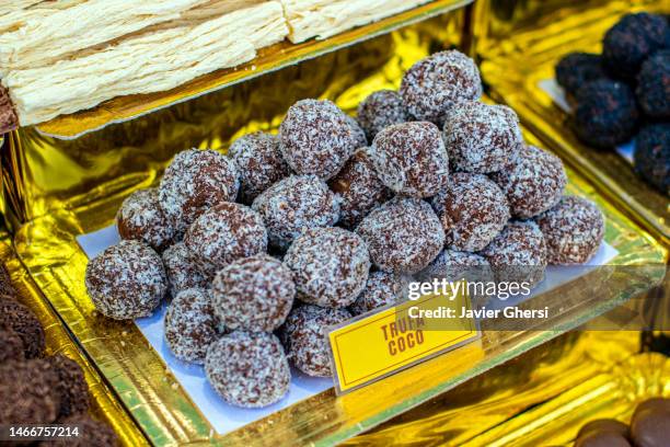 chocolate and dulce de leche truffles covered with grated coconut - milk chocolate truffles stock pictures, royalty-free photos & images