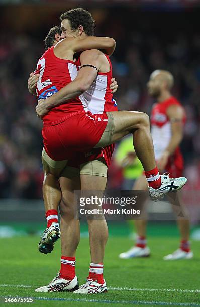 Josh Kennedy and Shane Mumford of the Swans celebrate victory during the round 13 AFL match between the Sydney Swans and the Geelong Cats at the...