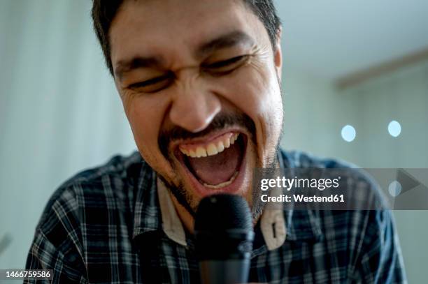 happy man singing at home - karaoke anlage stock-fotos und bilder