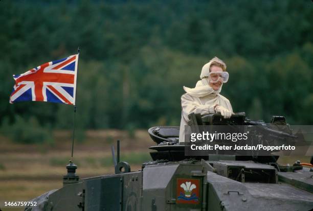 Conservative Party politician and Prime Minister of the United Kingdom Margaret Thatcher rides in the turret of a British Army Centurian tank at Bad...