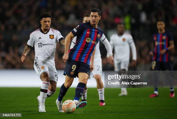 Jadon Sancho of Manchester United battles for possession with Robert Lewandowski of FC Barcelona during the UEFA Europa League knockout round...